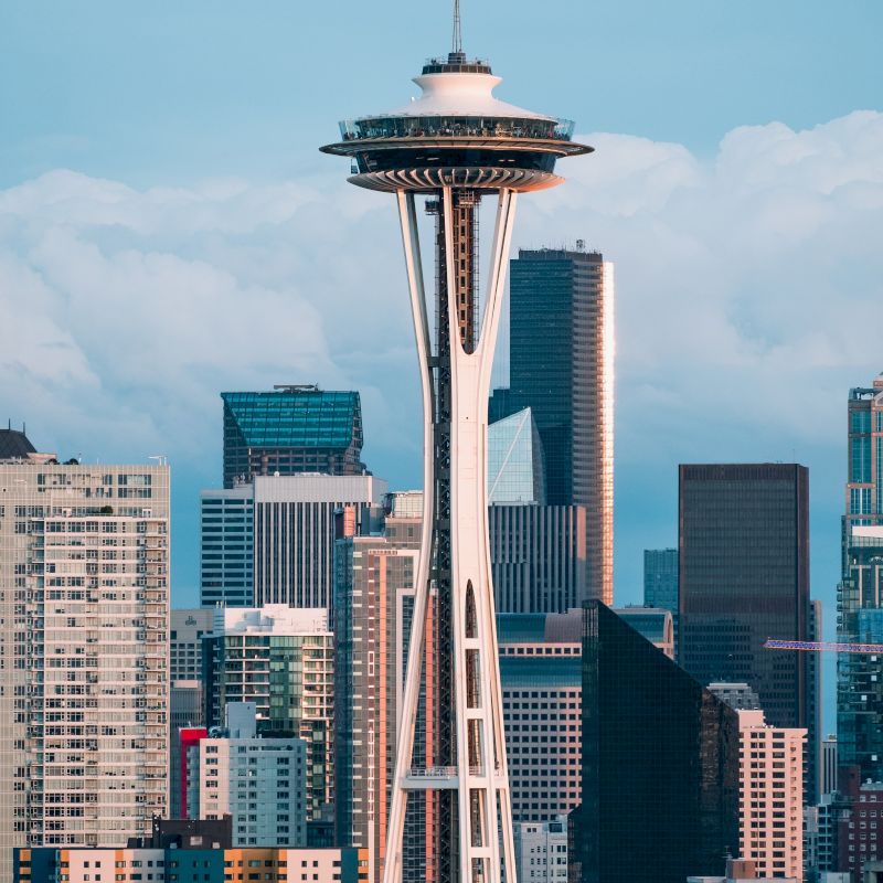 The image shows the Seattle skyline, prominently featuring the Space Needle among various buildings and skyscrapers.